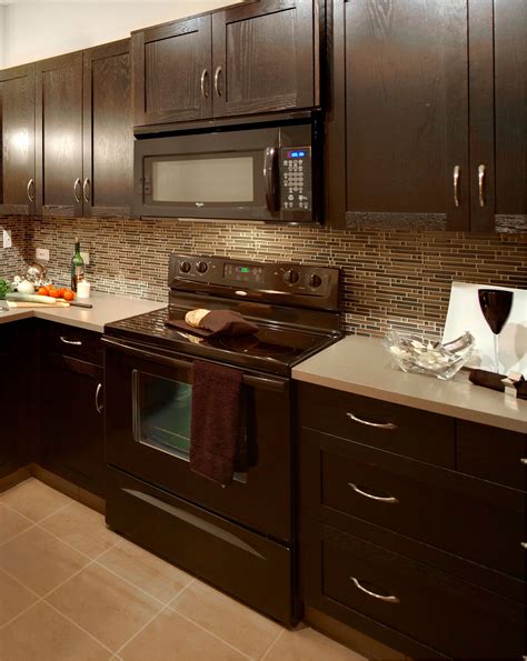 dark brown granite with light cabinets and stainless steel appliances|brown granite kitchen countertops.